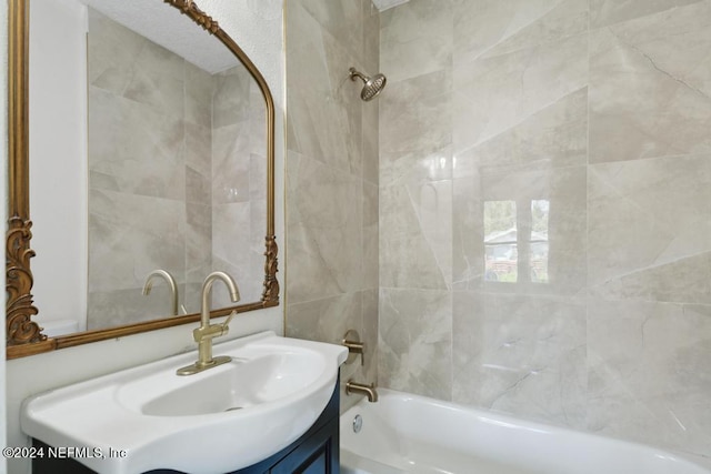 bathroom featuring vanity and tiled shower / bath combo