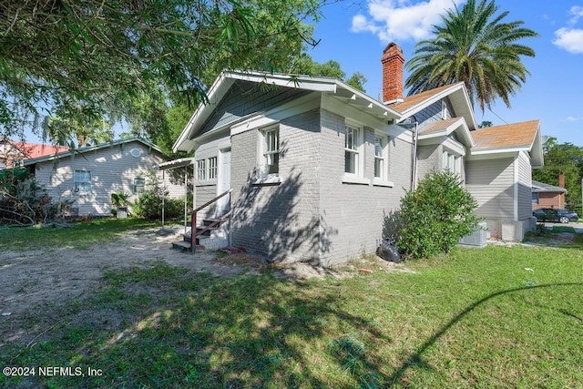 rear view of property with a yard