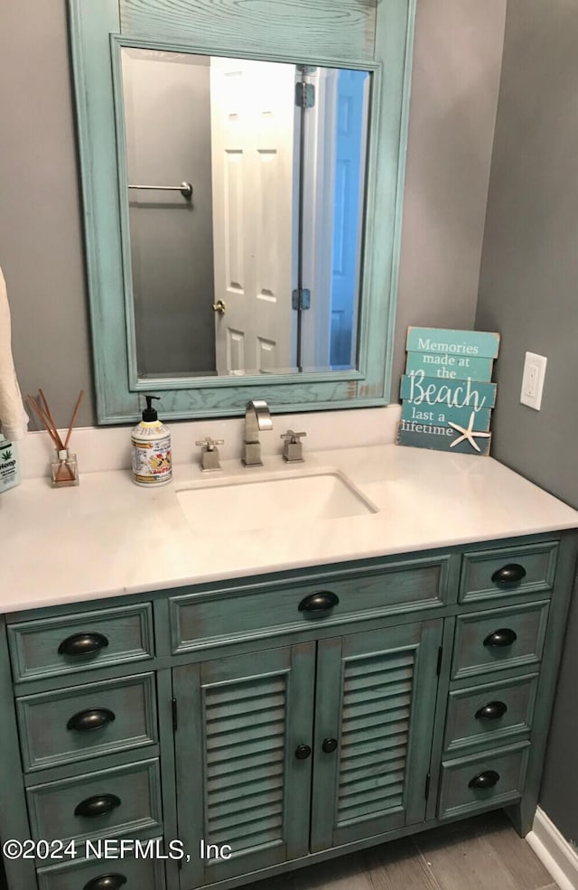 bathroom featuring vanity and hardwood / wood-style floors