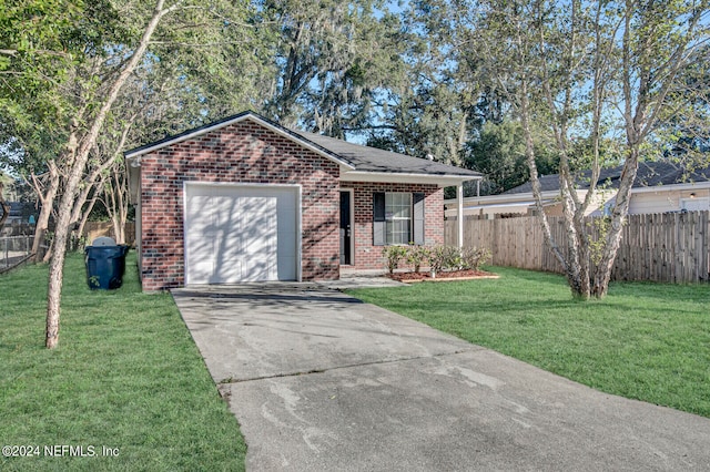 view of front of property with a garage and a front lawn