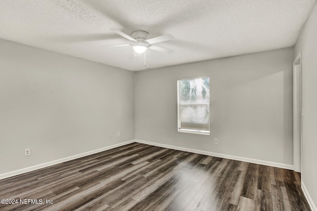 empty room with dark wood-type flooring, ceiling fan, and a textured ceiling