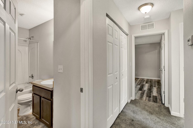 full bathroom with vanity, toilet, hardwood / wood-style flooring, and shower / bathing tub combination