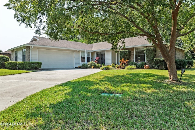 ranch-style house featuring a front yard and a garage