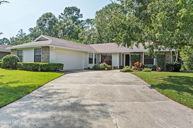 ranch-style home with a garage and a front lawn