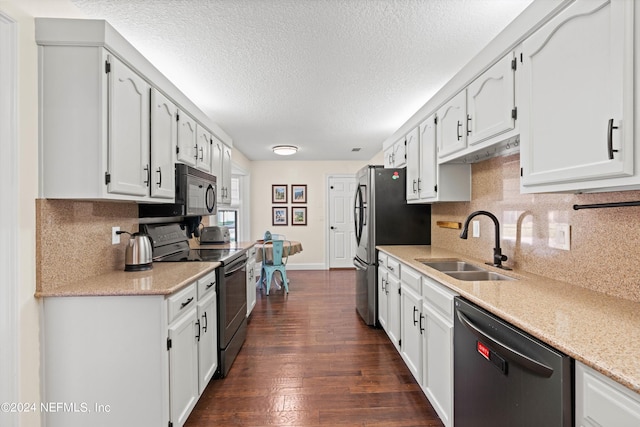 kitchen with dark wood-type flooring, stainless steel appliances, sink, and white cabinets