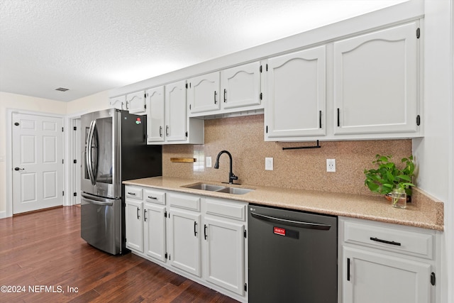 kitchen featuring decorative backsplash, white cabinets, dark hardwood / wood-style floors, sink, and stainless steel appliances