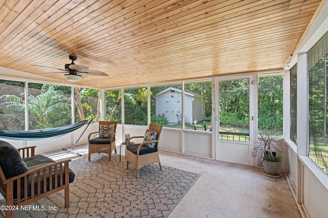 sunroom featuring wood ceiling, plenty of natural light, and ceiling fan