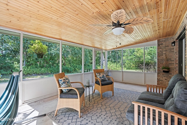 sunroom / solarium with wood ceiling, ceiling fan, and vaulted ceiling