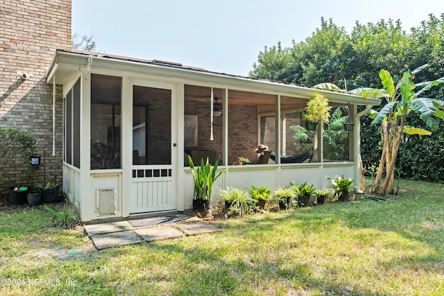 exterior space featuring a front yard and a sunroom