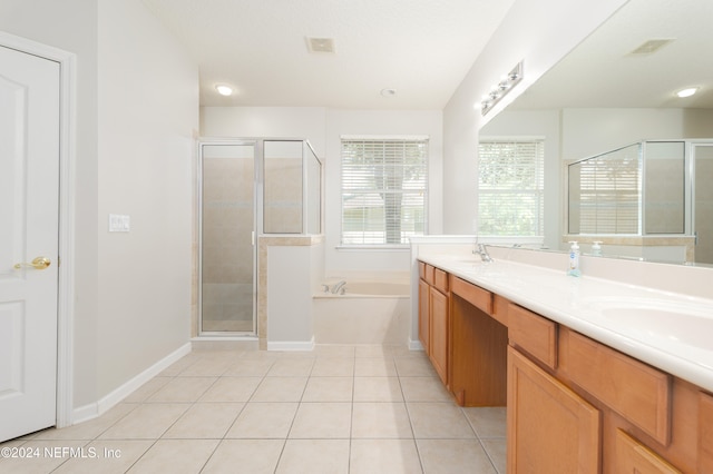 bathroom with vanity, independent shower and bath, and tile patterned flooring