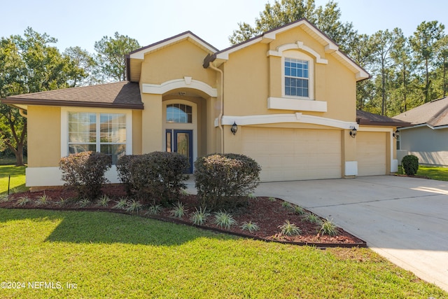 view of front of house featuring a front lawn and a garage