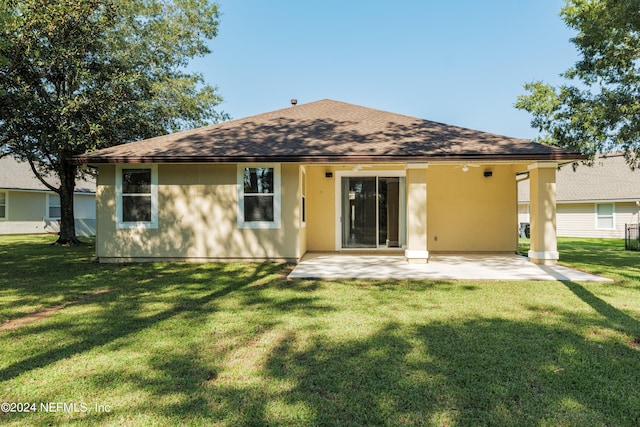 back of house with a yard and a patio area