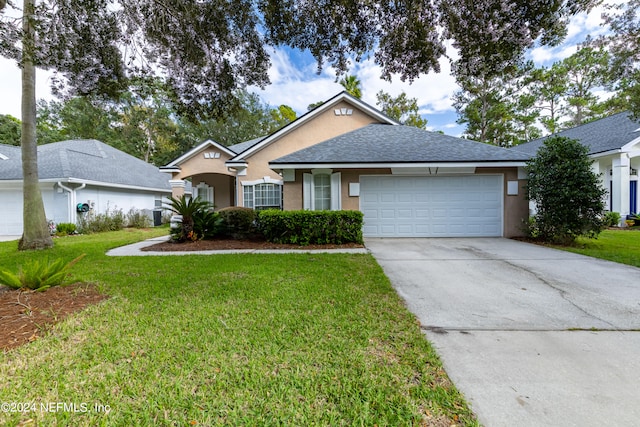 single story home featuring a garage and a front lawn