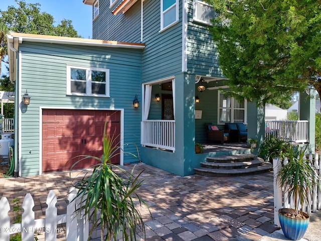 view of front of property with a porch and a garage