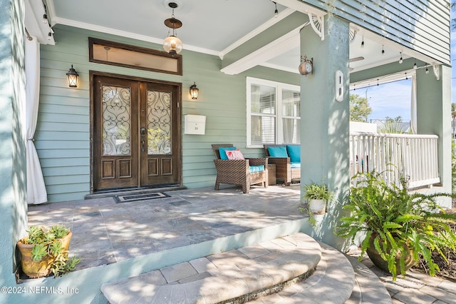 view of exterior entry featuring covered porch