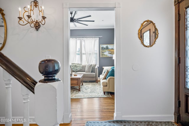 entryway featuring crown molding, hardwood / wood-style floors, and ceiling fan