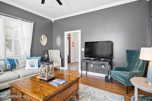 living room featuring ornamental molding, hardwood / wood-style flooring, and ceiling fan