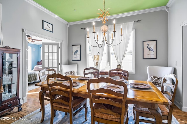 dining area featuring ornamental molding, wood-type flooring, and plenty of natural light