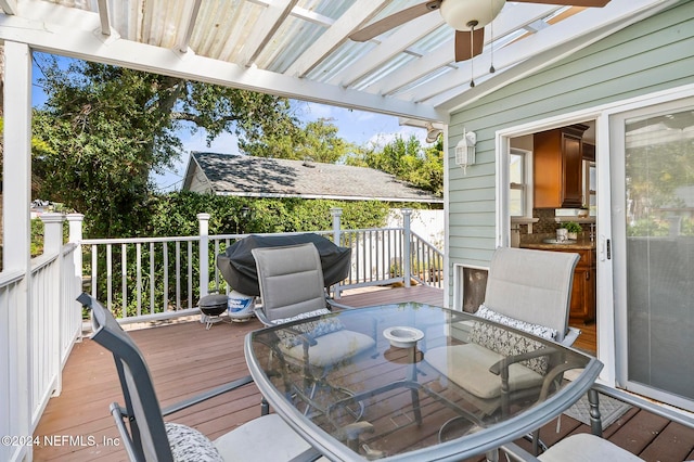 wooden terrace with a grill and ceiling fan