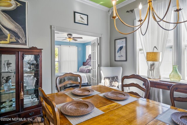 dining room featuring crown molding, ceiling fan with notable chandelier, and hardwood / wood-style floors