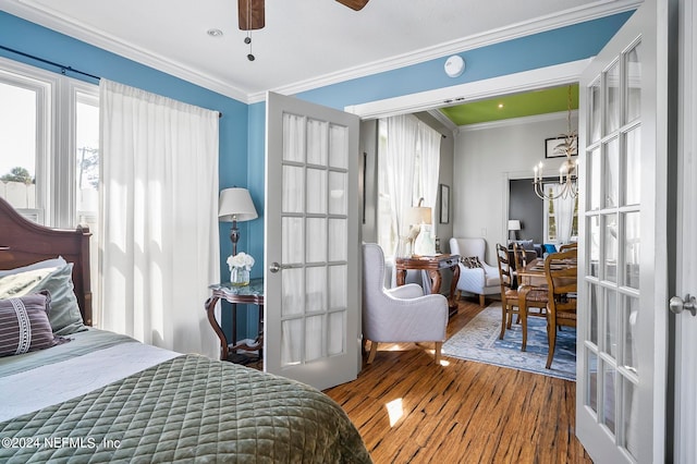 bedroom with french doors, hardwood / wood-style floors, ceiling fan, and crown molding