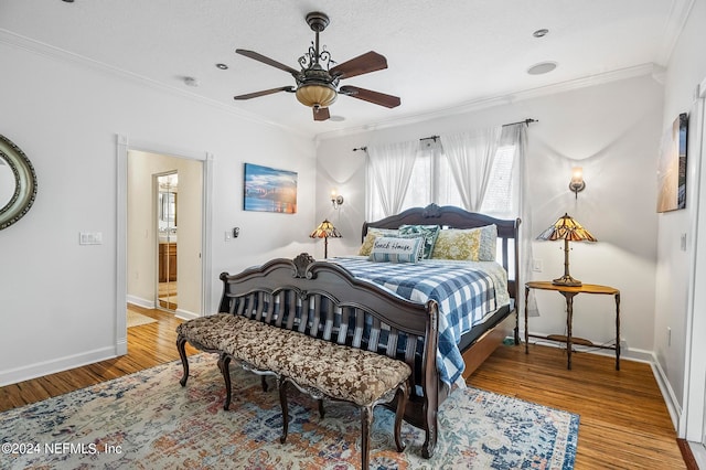 bedroom featuring crown molding, wood-type flooring, and ceiling fan