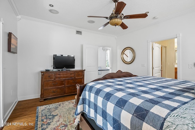 bedroom with ceiling fan, crown molding, wood-type flooring, and ensuite bath