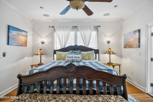 bedroom featuring ceiling fan, ornamental molding, and hardwood / wood-style floors