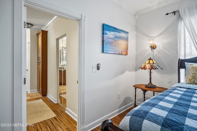 bedroom featuring crown molding and wood-type flooring