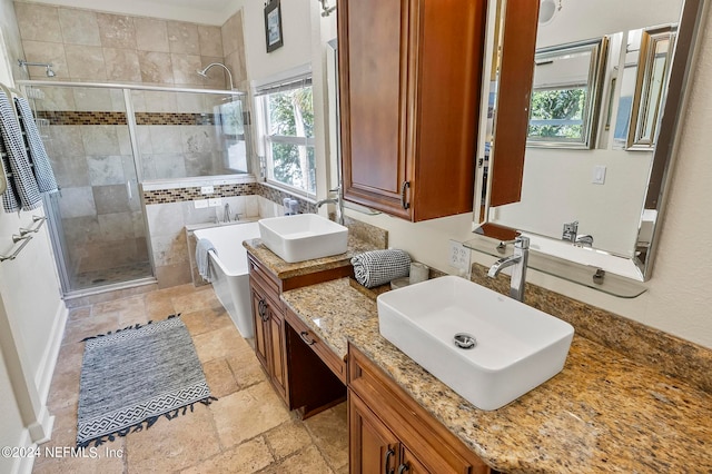 bathroom with vanity and independent shower and bath