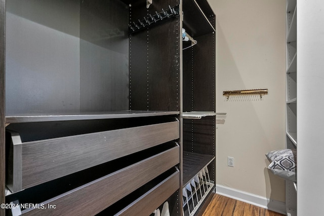 walk in closet with wood-type flooring