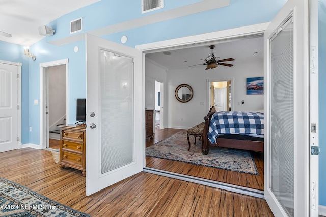 bedroom featuring ensuite bathroom, wood-type flooring, and ceiling fan