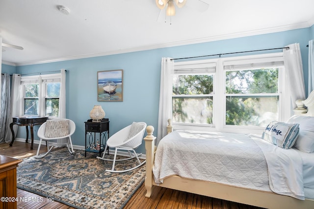 bedroom with ceiling fan, wood-type flooring, and multiple windows