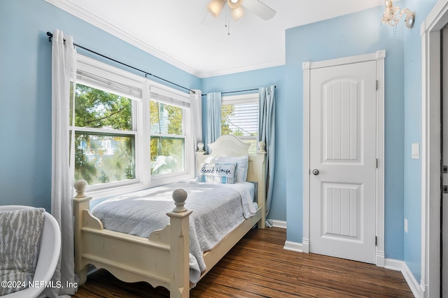 bedroom featuring ceiling fan, crown molding, and dark hardwood / wood-style floors