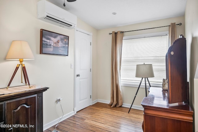 office featuring light hardwood / wood-style flooring and a wall unit AC