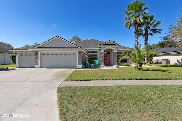 view of front of property featuring a front yard and a garage