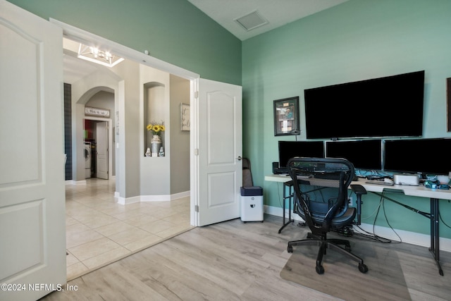 office area with light hardwood / wood-style flooring and washer / clothes dryer