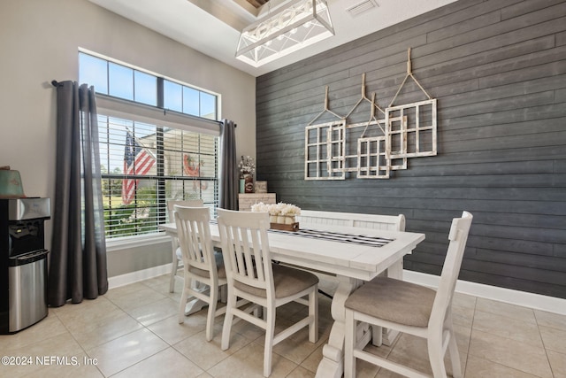 tiled dining space with wooden walls and plenty of natural light