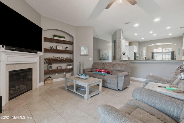 living room with light tile patterned flooring and ceiling fan