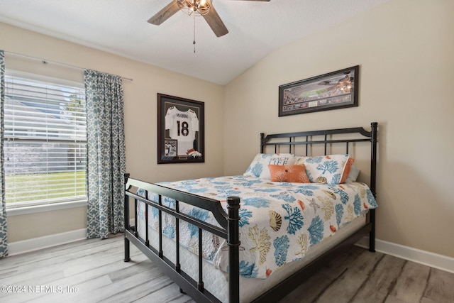 bedroom featuring ceiling fan, wood-type flooring, and lofted ceiling