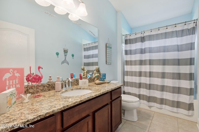 bathroom featuring toilet, vanity, tile patterned floors, and a shower with shower curtain