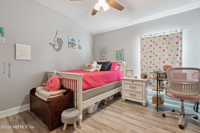 bedroom with light hardwood / wood-style floors, vaulted ceiling, and ceiling fan