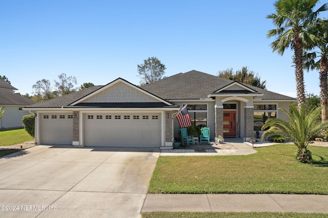 view of front facade featuring a front yard and a garage