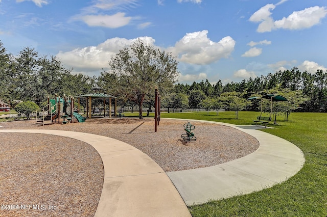 view of community with a gazebo, a playground, and a lawn