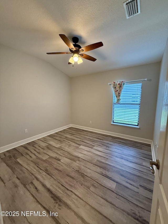 32540 Willow Parke Cir, Fernandina Beach, FL 32034 - unfurnished room featuring ceiling fan, wood finished floors, baseboards, and a textured ceiling