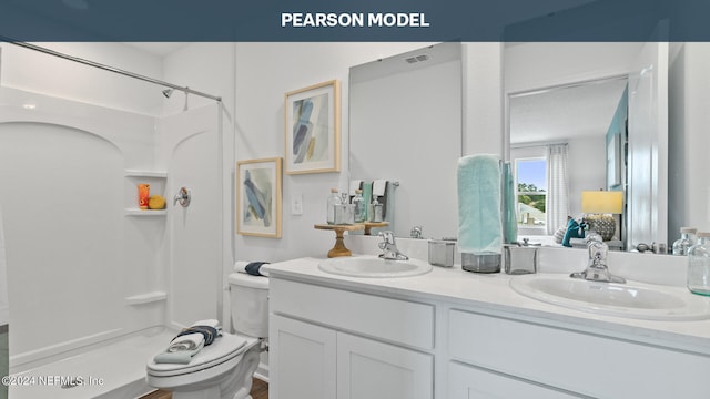 full bath with a shower stall, double vanity, and toilet