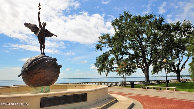 surrounding community featuring a water view