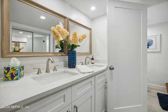 bathroom featuring vanity and hardwood / wood-style flooring