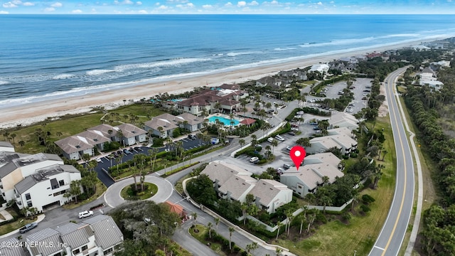 bird's eye view featuring a water view and a beach view