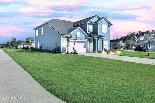 view of front property with a garage and a yard